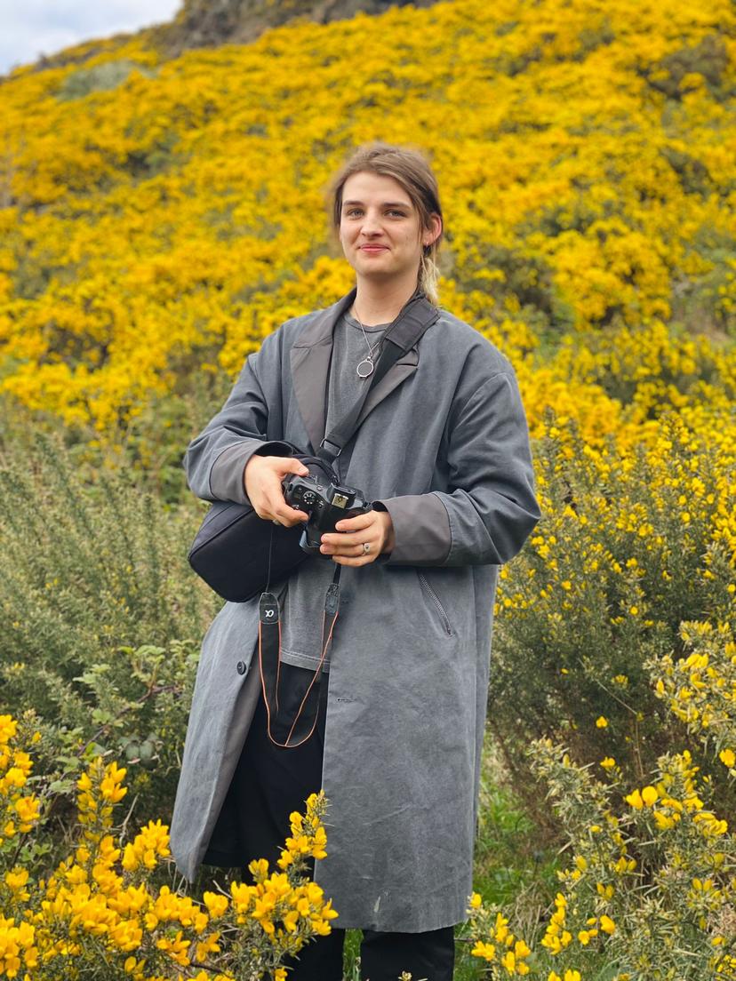 Rudy Boutte in front of yellow flowers